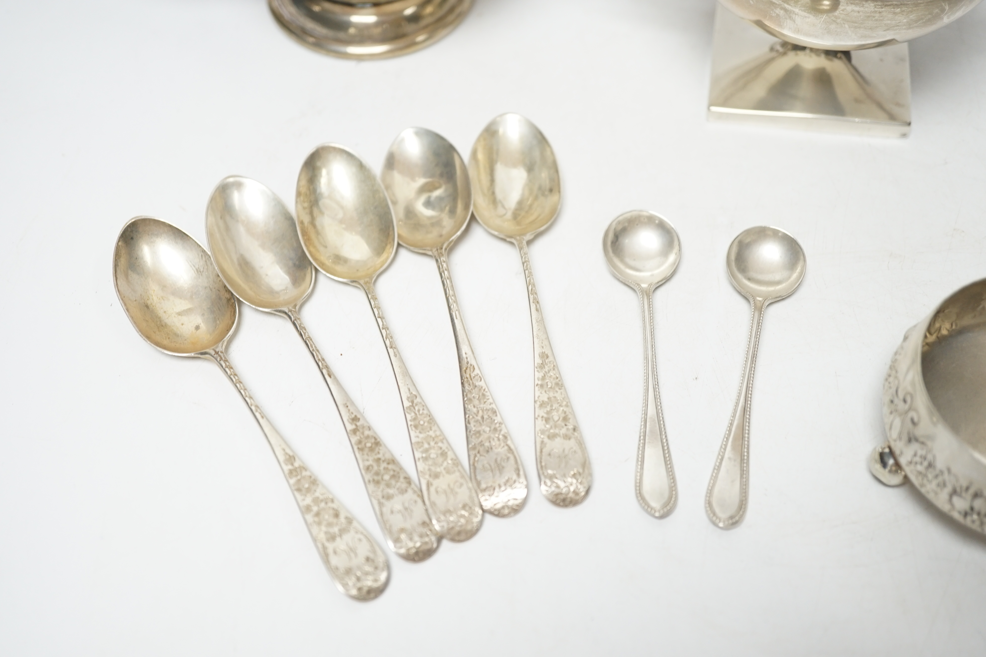 An Edwardian silver two handled bowl, Chester, 1902, diameter 10.4cm, a sterling bowl, a pair of engraved silver tub salts and matching salt spoons, Mappin & Webb, Sheffield, 1908 and a set of five silver teaspoons.